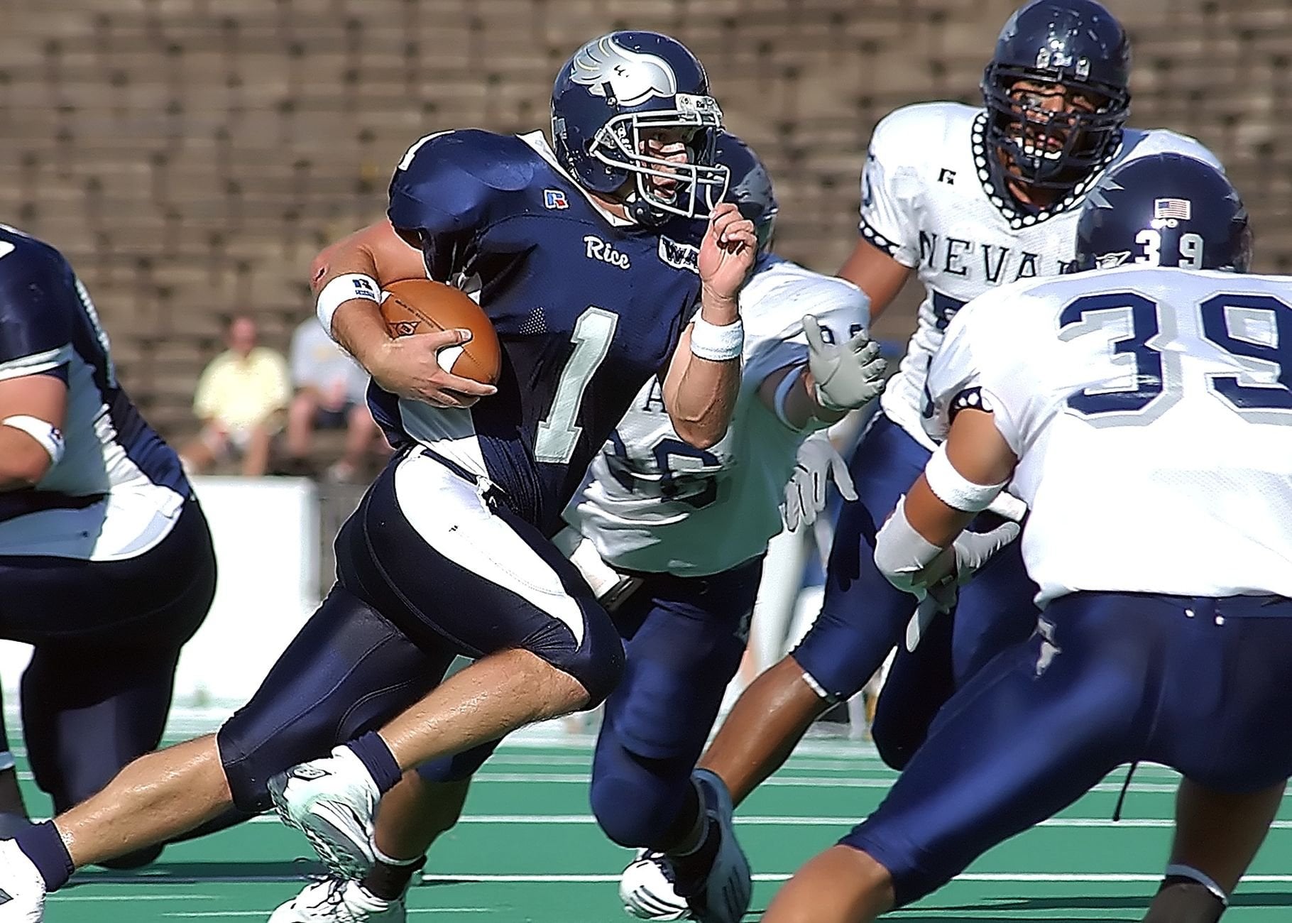Athletes competing in an intense American football match on the field